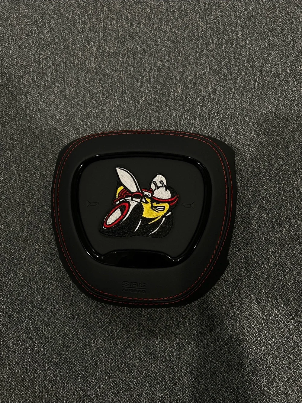 Black Airbag Cover with Red Stitching and Bee Patch